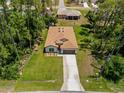 Aerial view showcases the home's location and surrounding landscape with ample trees at 3802 Eagle Pass St, North Port, FL 34286