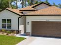 View of the house exterior featuring modern design elements and a well-maintained landscape at 3802 Eagle Pass St, North Port, FL 34286