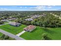 Expansive aerial view of a single-story house on a large lot, nestled among lush greenery and neighboring homes at 4637 Irdell Ter, North Port, FL 34288