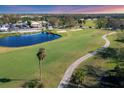 Aerial view of a beautiful golf course with pond at 766 Village Cir # 225, Venice, FL 34292