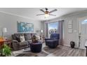 Relaxing living room with gray recliner chair, and a cat sitting on an ottoman at 8718 Gaillard Ave, North Port, FL 34287