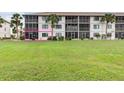 Exterior view of condo building showcasing a ground floor unit at 175 Kings Hwy # 718, Punta Gorda, FL 33983