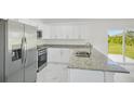 Modern kitchen with stainless steel appliances and granite countertops at 11505 3Rd Ave, Punta Gorda, FL 33955
