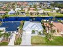 Aerial view of waterfront home with canal access and lush landscaping at 1450 Kiwi Ct, Punta Gorda, FL 33950