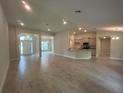 Spacious living room and kitchen area with recessed lighting and modern finishes at 27462 Pasto Dr, Punta Gorda, FL 33983