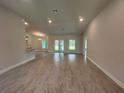 Open-concept living room featuring tile flooring and ample natural light at 27462 Pasto Dr, Punta Gorda, FL 33983