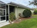 House exterior showcasing landscaping and a screened enclosure at 5101 Pine Shadow Ln, North Port, FL 34287