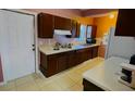 Simple kitchen with dark wood cabinets and appliances at 554 Lindley Ter, Port Charlotte, FL 33952