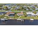 Waterfront home with a boat dock, pool, and lush greenery in a residential neighborhood at 201 W Tarpon Nw Blvd, Port Charlotte, FL 33952