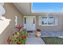 Inviting front entrance with decorative seahorse, flower planters, and a well-lit porch at 201 W Tarpon Nw Blvd, Port Charlotte, FL 33952
