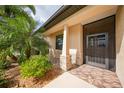 Front entry with decorative screen door and stone accents at 632 Rose Apple Cir, Port Charlotte, FL 33954