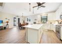 Spacious kitchen featuring white cabinets, stainless steel appliances, and an island at 632 Rose Apple Cir, Port Charlotte, FL 33954