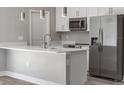 Modern kitchen with stainless steel appliances and white cabinets at 1430 Nora Ln, North Port, FL 34286
