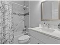 Clean bathroom with white vanity, marble shower, and a toilet at 1497 Nordendale Blvd, North Port, FL 34288