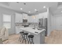 Modern kitchen with white cabinets, stainless steel appliances, and an island at 1497 Nordendale Blvd, North Port, FL 34288