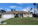 One-story home with a screened porch and well-manicured lawn at 2250 Villa Green Ave, North Port, FL 34288