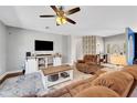 Living room with a flat-screen TV, comfortable seating, and a wooden coffee table at 2794 Parlay Ln, North Port, FL 34286