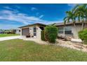 House exterior showcasing a well-maintained lawn, landscaped garden, and attractive facade at 3545 Syracuse St, Port Charlotte, FL 33952