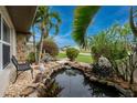 Relaxing water feature with a pond and waterfall creates a tranquil outdoor space at 3545 Syracuse St, Port Charlotte, FL 33952