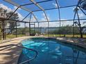 Relaxing screened pool overlooking the water at 3608 Peace River Dr, Punta Gorda, FL 33983