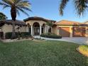 Two-story house with a two-car garage and well-manicured lawn at 4201 Eagle Nest Ct, Port Charlotte, FL 33948