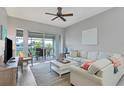 Bright living room with comfy seating and access to a balcony at 5117 Melbourne St # B302, Punta Gorda, FL 33980