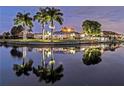 Waterfront home at night, illuminated, reflecting in calm water at 803 Napoli Ln, Punta Gorda, FL 33950