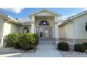 House entrance with double doors and manicured landscaping at 1375 Grebe Dr, Punta Gorda, FL 33950