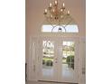 Bright entryway with double doors and a large window at 1375 Grebe Dr, Punta Gorda, FL 33950