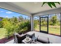 Relaxing screened porch with comfortable seating at 15257 Mille Fiore Blvd, Port Charlotte, FL 33953