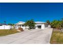 Charming single-story home with a welcoming front yard and paved driveway at 170 Chelsea Nw Ct, Port Charlotte, FL 33952