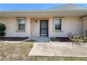 Inviting front entrance featuring a well-kept walkway, flowers, and a neutral color scheme at 25068 Harborview Rd # 1A, Punta Gorda, FL 33980