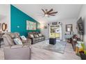 Relaxing living room with gray couches and a teal accent wall at 4340 Adolph Ave, North Port, FL 34288