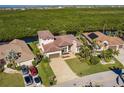 Bird's-eye view of a waterfront home with a large backyard and neighboring houses at 681 Macedonia Dr, Punta Gorda, FL 33950