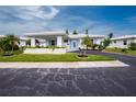 Mid-century modern home with carport and well-maintained landscaping at 8730 Pickwick Rd, North Port, FL 34287