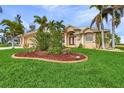 Two-story house with a manicured lawn and tropical landscaping at 15460 Longview Rd, Port Charlotte, FL 33981