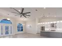 Open concept living area with high ceilings and modern kitchen at 17183 Ohara Dr, Port Charlotte, FL 33948