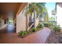 Condo hallway with access to outdoor stairs and landscaping at 23465 Harborview Rd # 1028, Punta Gorda, FL 33980