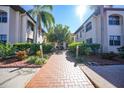 Welcoming condo building entrance with landscaped walkway at 23465 Harborview Rd # 1028, Punta Gorda, FL 33980