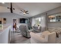 Spacious living room with grey couches, large TV, and wood-look floors at 26352 Copiapo Cir, Punta Gorda, FL 33983