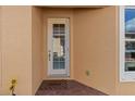 Exterior view of home featuring a side entrance and brick walkway at 4410 Turnberry Cir, North Port, FL 34288