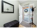 Inviting entryway with bench, mirror, and coat rack at 19310 Water Oak Dr # 203, Port Charlotte, FL 33948