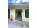 Covered porch and garage featuring a charming architectural archway and stucco exterior at 4290 Randypaar St, Port Charlotte, FL 33948