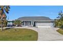 Inviting single-story home with a two-car garage, RV parking and well maintained landscaping at 5198 White Ave, Port Charlotte, FL 33981