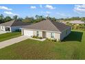 Aerial view of a one-story home with a landscaped yard at 820 Haleybury St, Port Charlotte, FL 33948