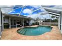 Screened-in pool with a large patio area at 1370 Kenmore St, Port Charlotte, FL 33952