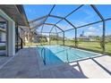 Relaxing screened-in pool with clear water and paved patio perfect for outdoor enjoyment at 182 Santarem Cir, Punta Gorda, FL 33983