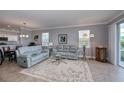 Light and airy living room with two sofas and a large rug at 25623 Heritage Lake Blvd. # 57, Punta Gorda, FL 33983