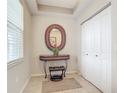 Bright entryway with mirror, console table, and closet at 5115 Melbourne St # A206, Punta Gorda, FL 33980