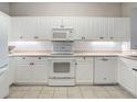 White kitchen with microwave, stove, and dishwasher at 5115 Melbourne St # A206, Punta Gorda, FL 33980
